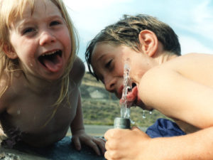 Hot little Paris and brother Alex drink from eastern Oregon fountain